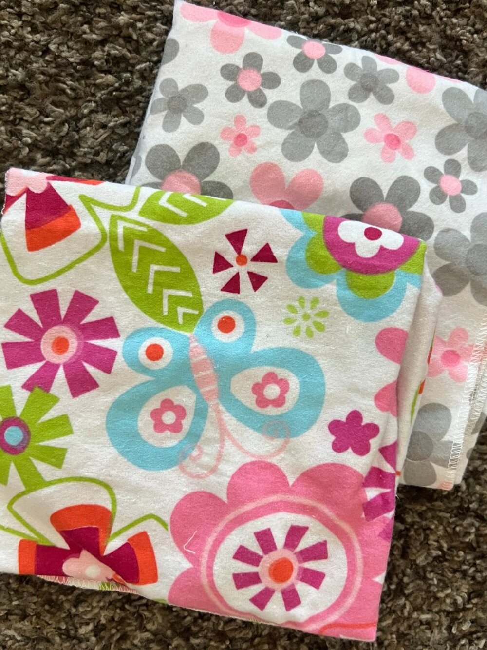 2 bright patterned baby blankets